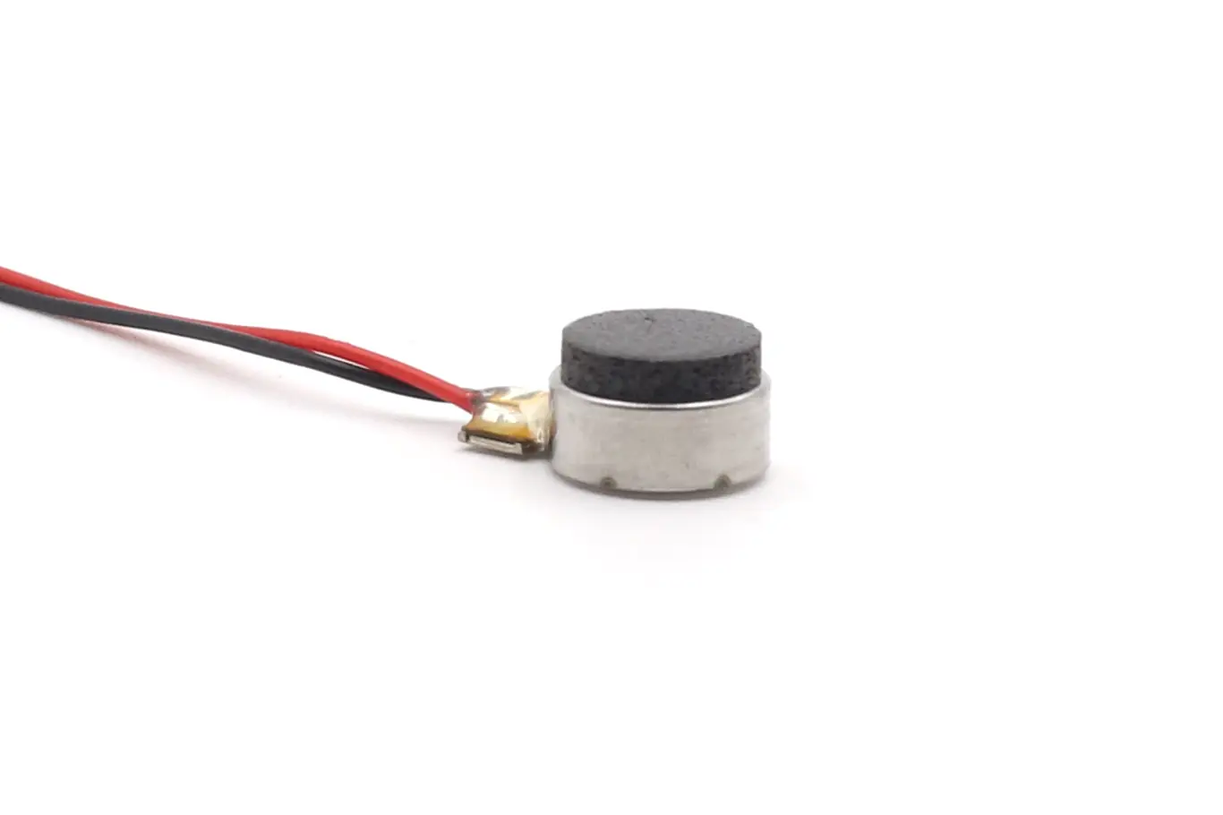 1040 LRA coin-type haptic feedback motor with black dampening foam and lead wires