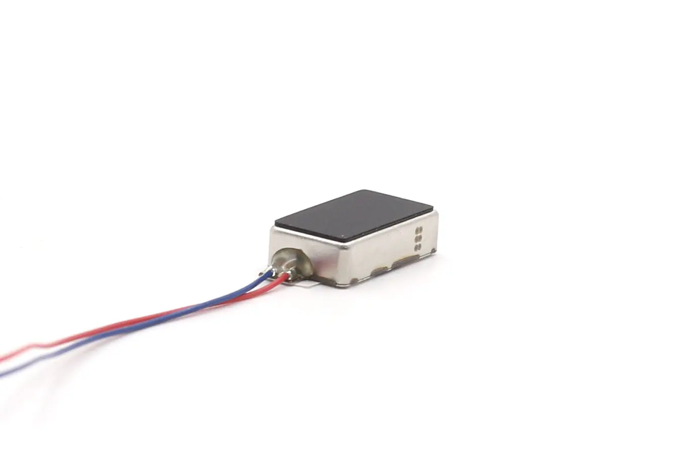 Close-up detail of the reinforced, glue-sealed wire terminal connection on the haptic feedback actuator motor.